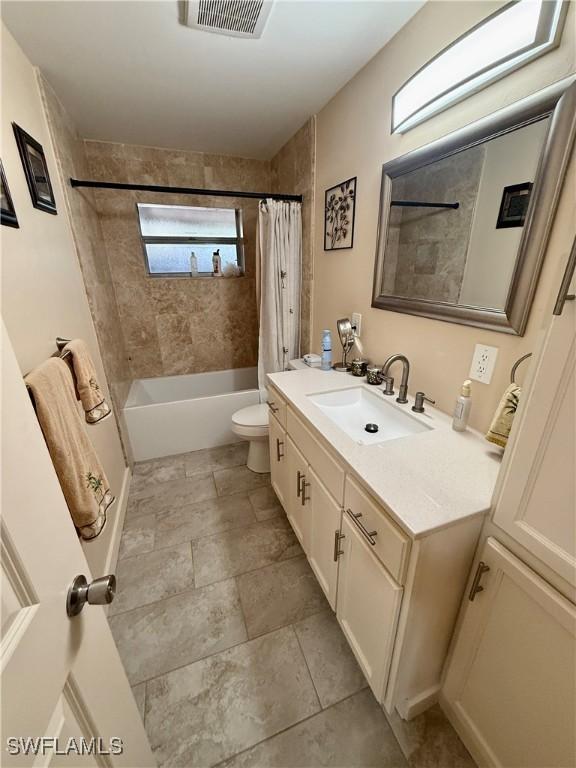 full bathroom featuring toilet, vanity, and shower / bath combo