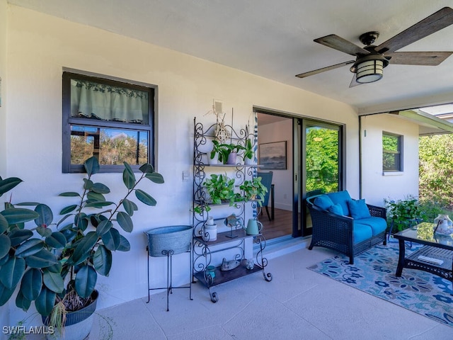 sunroom / solarium featuring ceiling fan