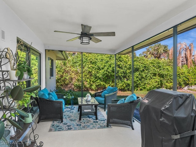 sunroom / solarium with a ceiling fan and visible vents