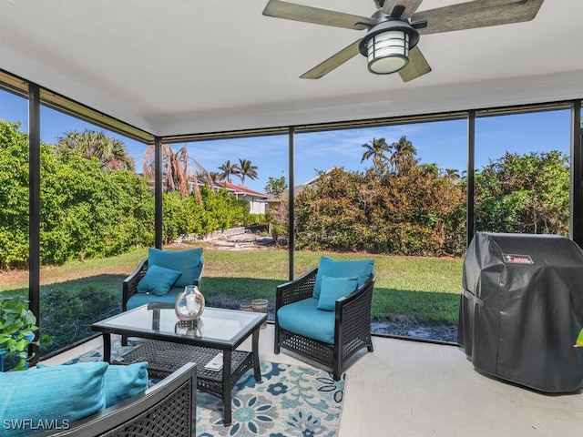 sunroom featuring a ceiling fan