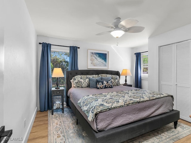 bedroom with a closet, hardwood / wood-style flooring, and ceiling fan