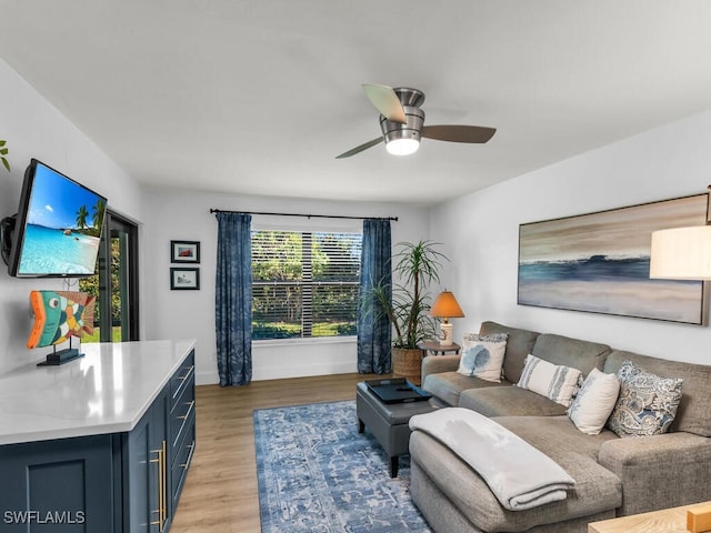 living room with light wood-type flooring and ceiling fan