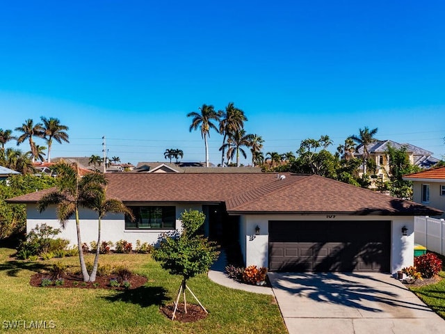 ranch-style house featuring driveway, a shingled roof, an attached garage, a front lawn, and stucco siding