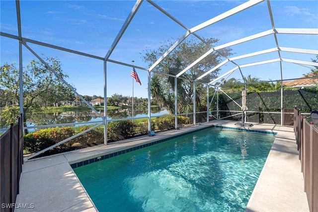 view of pool featuring a lanai, a patio area, and a water view