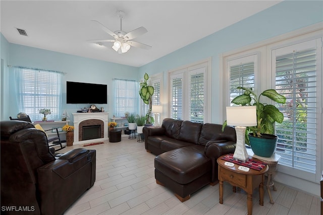 living room featuring ceiling fan and a healthy amount of sunlight