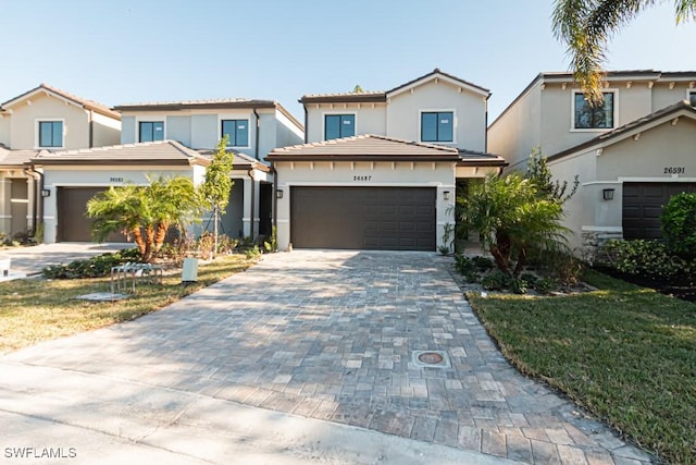 view of front of home with a front lawn and a garage