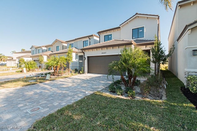 view of front of property featuring a garage and a front lawn