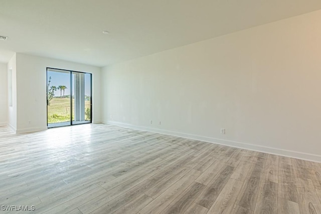 empty room with light hardwood / wood-style floors