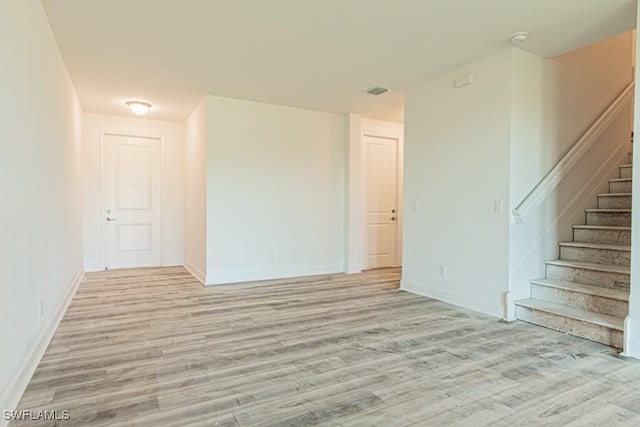 empty room with light hardwood / wood-style flooring