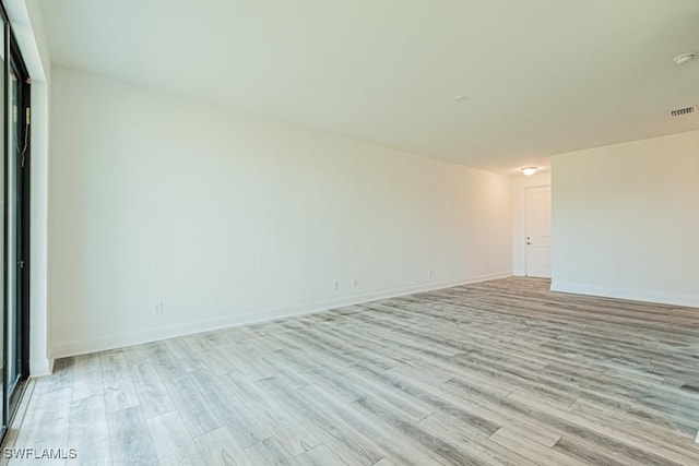 spare room featuring light hardwood / wood-style flooring