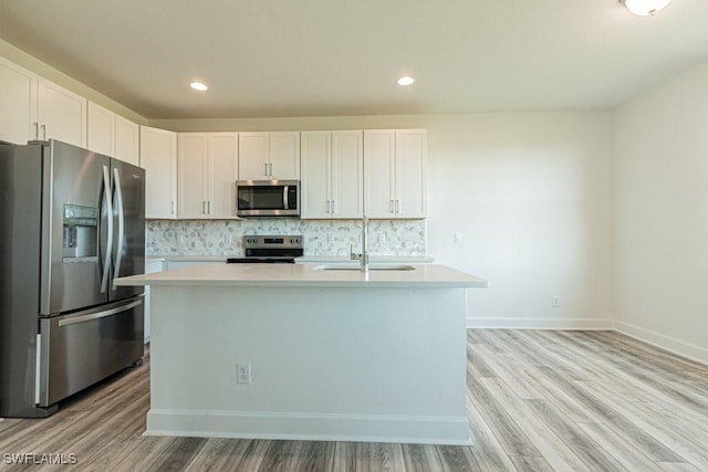 kitchen with white cabinetry, a kitchen island with sink, and appliances with stainless steel finishes