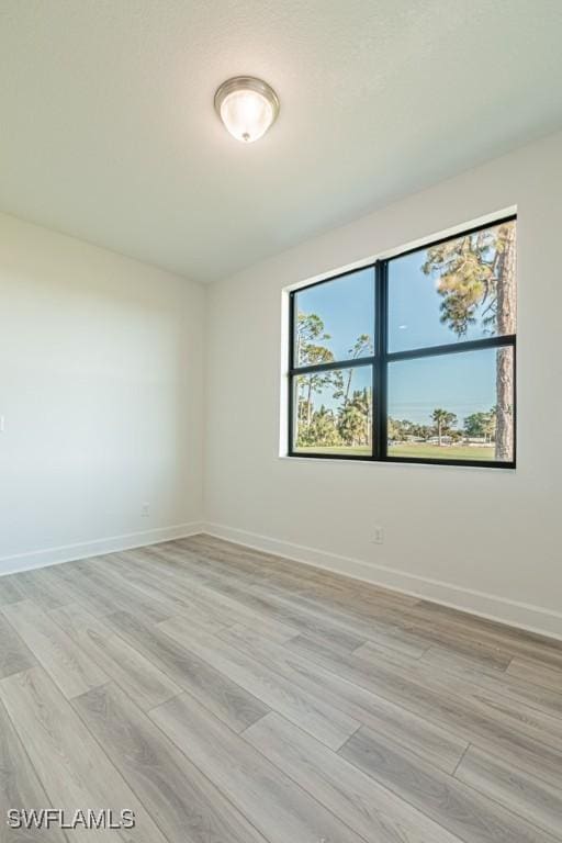 unfurnished room featuring light hardwood / wood-style floors