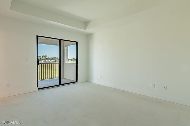 spare room featuring a tray ceiling