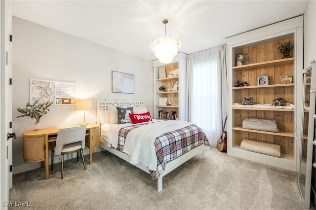 carpeted bedroom with a notable chandelier