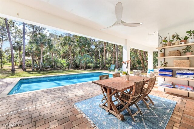 view of pool with ceiling fan and a patio