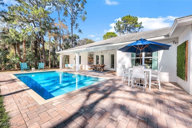 view of pool featuring a patio and ceiling fan