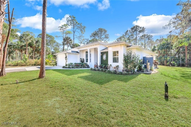 view of front of property featuring a garage and a front lawn