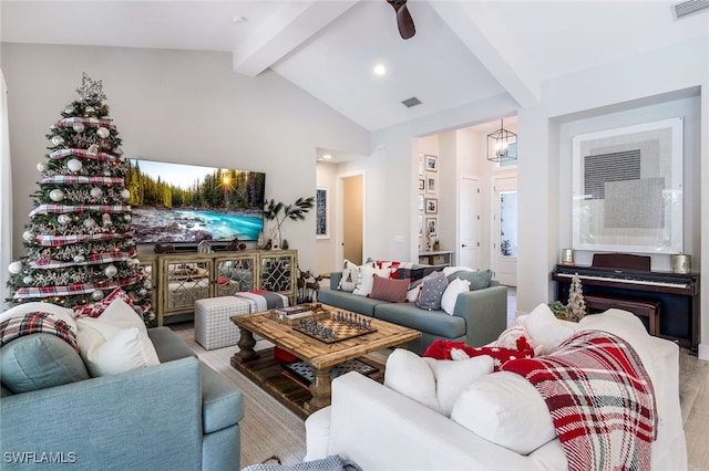 living room with hardwood / wood-style floors, vaulted ceiling with beams, and ceiling fan