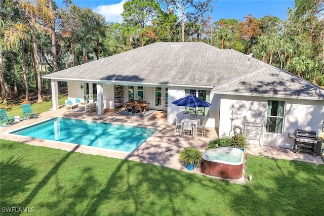 back of house with a yard and a patio