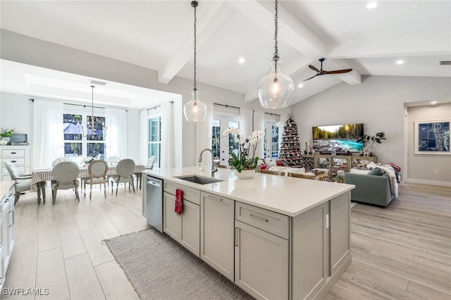 kitchen featuring ceiling fan, a kitchen island with sink, sink, dishwasher, and hanging light fixtures