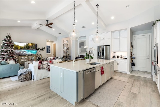 kitchen with a kitchen island with sink, sink, light hardwood / wood-style floors, white cabinetry, and stainless steel appliances