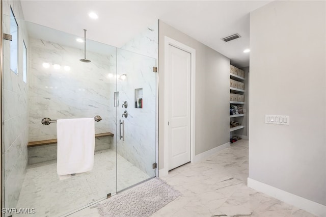 bathroom with a shower with door