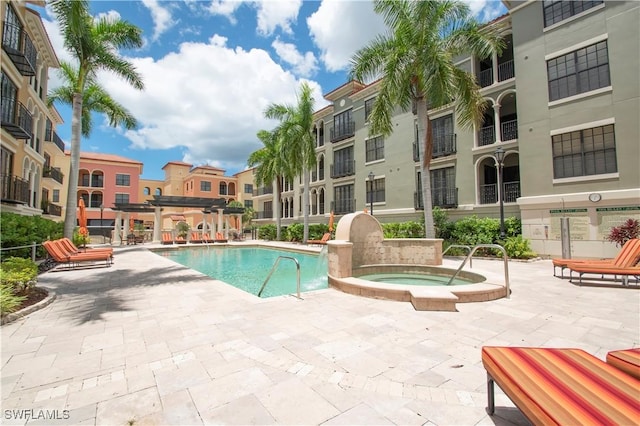 view of swimming pool with a pergola, a patio, and a hot tub