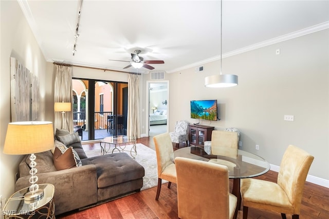 living room featuring ceiling fan, rail lighting, wood-type flooring, and ornamental molding