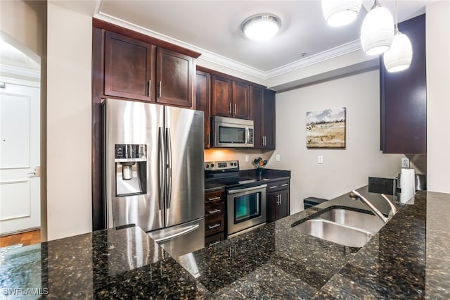 kitchen featuring appliances with stainless steel finishes, dark stone counters, ornamental molding, sink, and decorative light fixtures