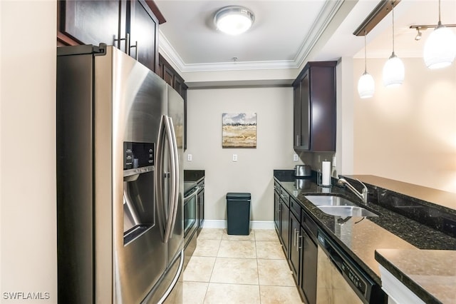 kitchen with sink, dark stone countertops, pendant lighting, dark brown cabinets, and appliances with stainless steel finishes