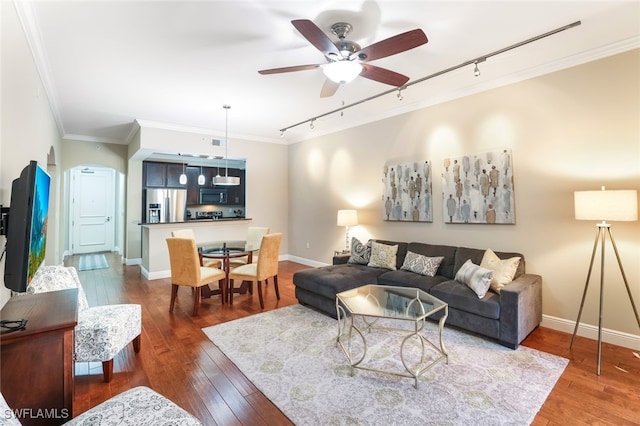 living room with ceiling fan, dark hardwood / wood-style flooring, crown molding, and track lighting