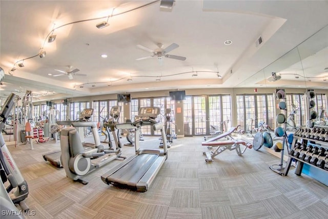 exercise room featuring light carpet and ceiling fan