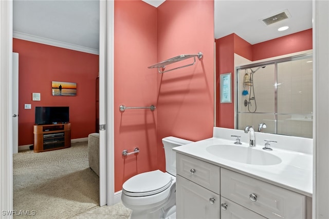 bathroom featuring crown molding, vanity, an enclosed shower, and toilet