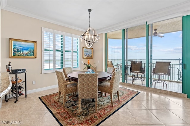 tiled dining space with ceiling fan with notable chandelier and ornamental molding