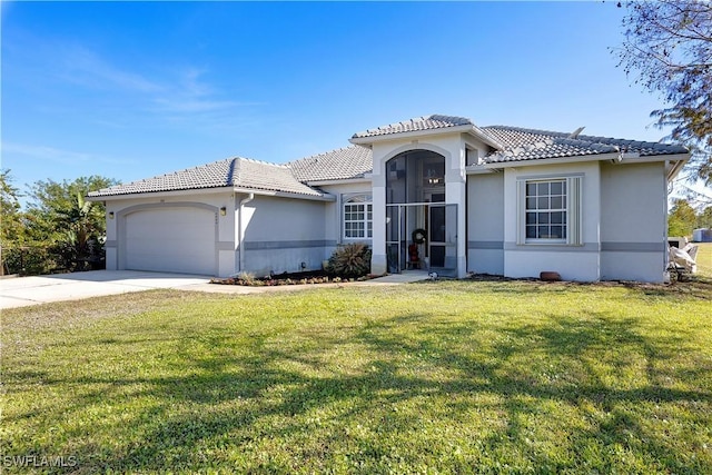 mediterranean / spanish-style house with a garage and a front yard