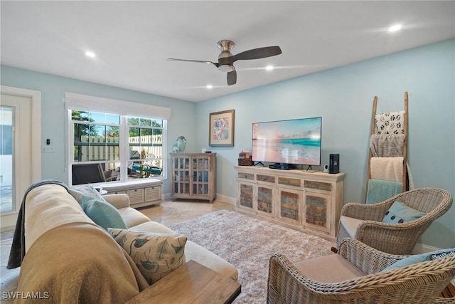 living room featuring light tile patterned floors and ceiling fan