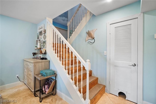 staircase featuring tile patterned floors