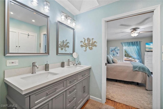 bathroom featuring wood-type flooring, vanity, and ceiling fan