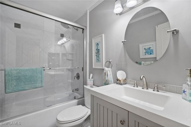 full bathroom with vanity, toilet, shower / bath combination with glass door, and crown molding