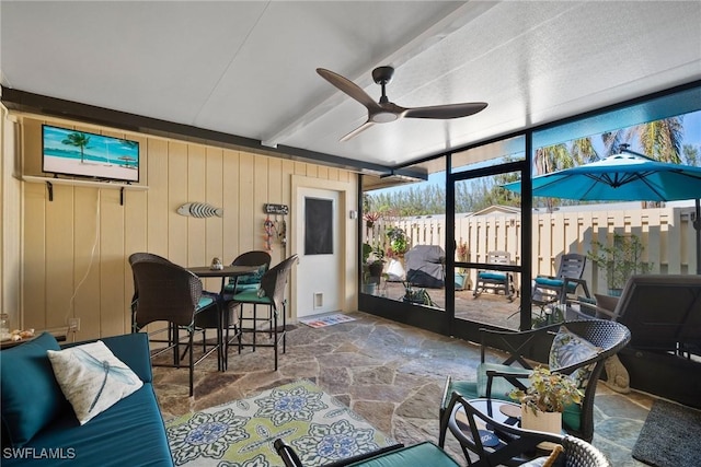 sunroom featuring ceiling fan