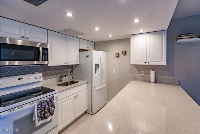 3 Bob O Link Ct Unit 3B, Naples, FL 34105 - kitchen featuring white cabinets, decorative backsplash, white appliances, and sink