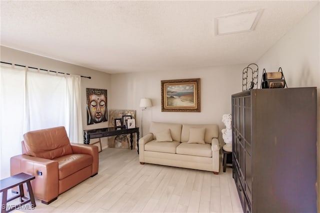 3 Bob O Link Ct Unit 3B, Naples, FL 34105 - living room with light wood-style flooring and a textured ceiling