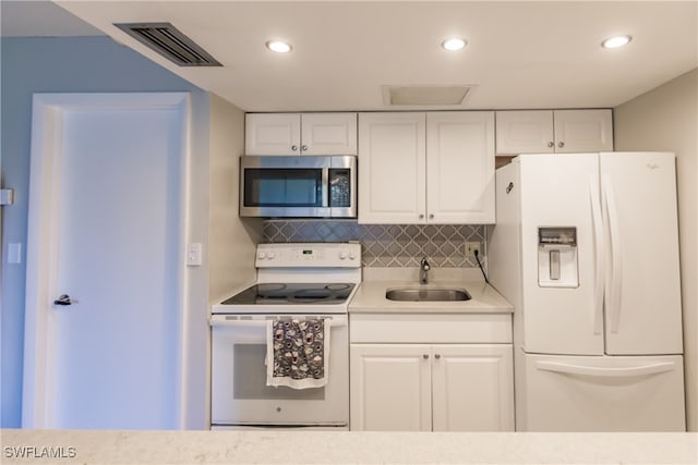 3 Bob O Link Ct Unit 3B, Naples, FL 34105 - kitchen featuring white cabinets, decorative backsplash, white appliances, and sink