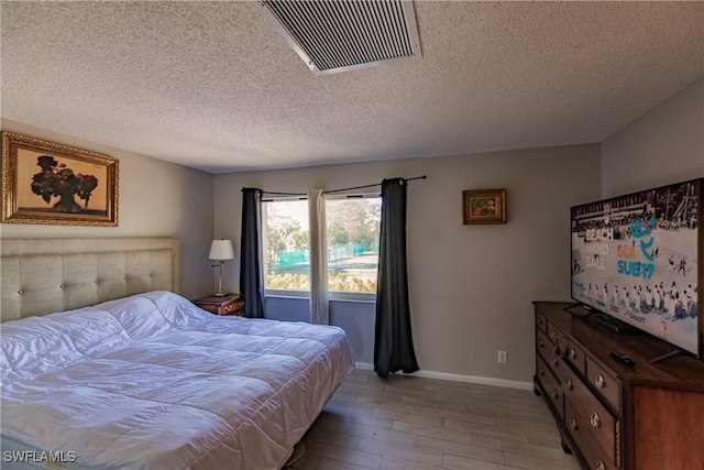 3 Bob O Link Ct Unit 3B, Naples, FL 34105 - bedroom featuring a textured ceiling and light wood-type flooring