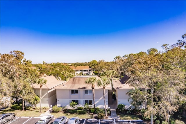 3 Bob O Link Ct Unit 3B, Naples, FL 34105 - view of front of property with uncovered parking and stucco siding