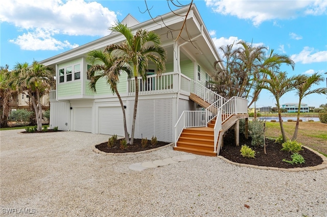 view of home's exterior featuring covered porch and a garage