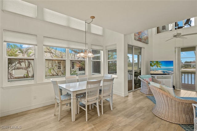 sunroom with ceiling fan with notable chandelier and plenty of natural light