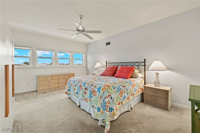 bedroom featuring ceiling fan and light carpet