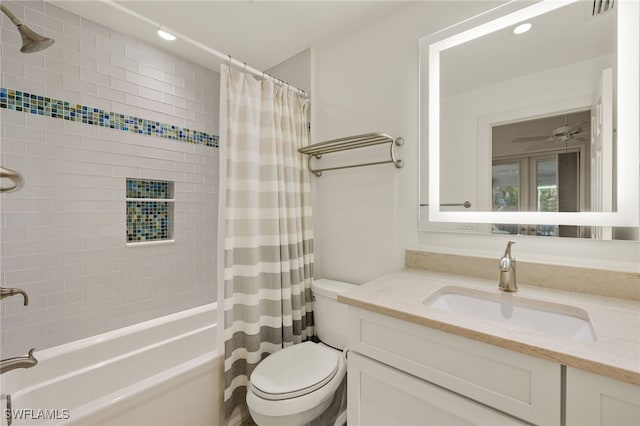 full bathroom featuring vanity, ceiling fan, toilet, and shower / bathtub combination with curtain