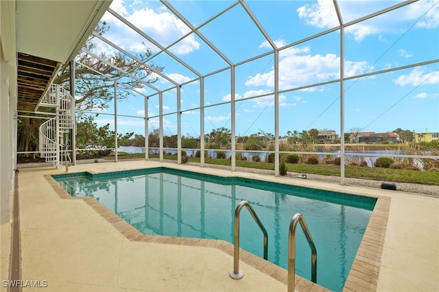 view of pool featuring glass enclosure and a patio area